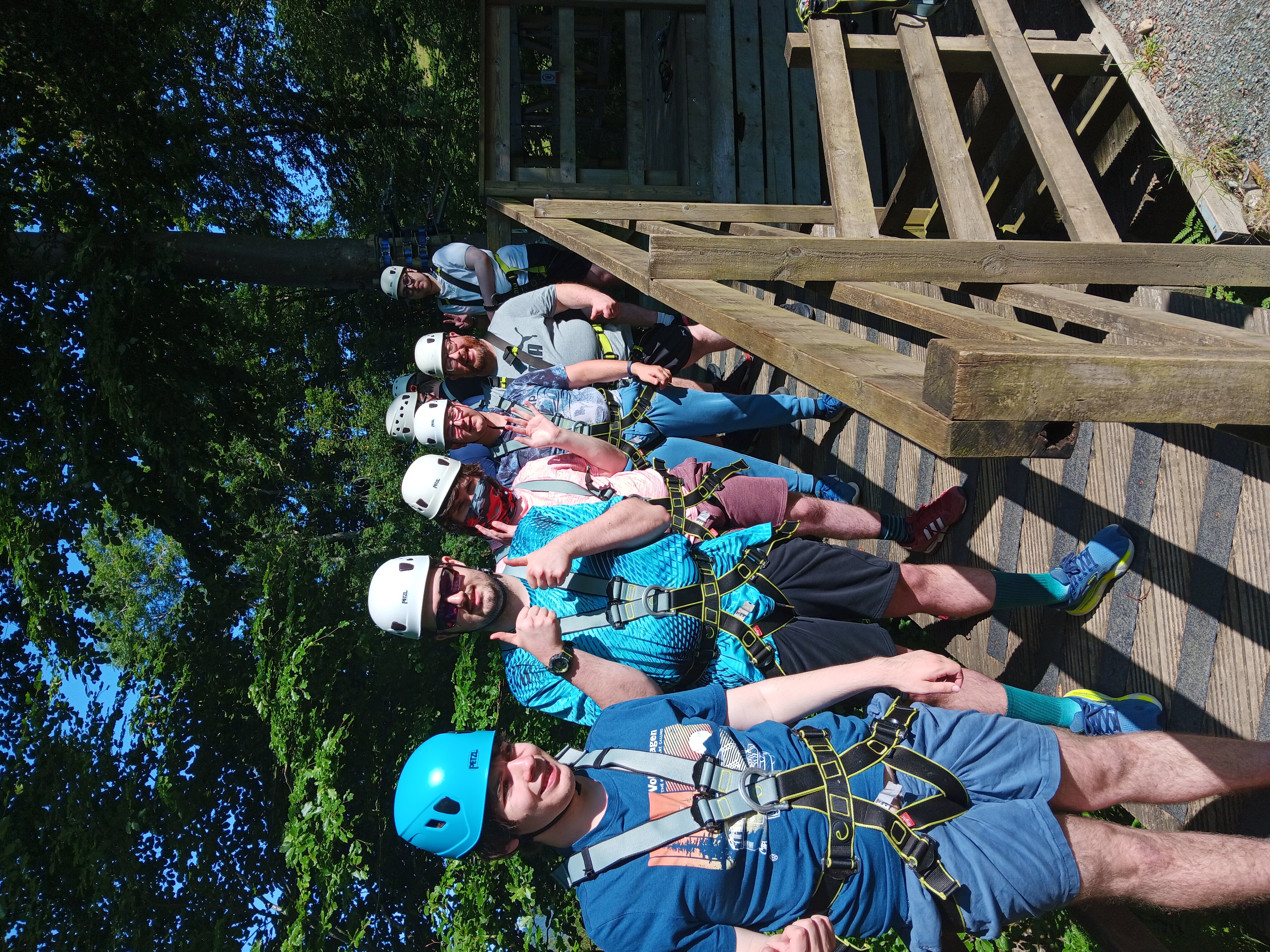 A group of students lining up across a treetop course