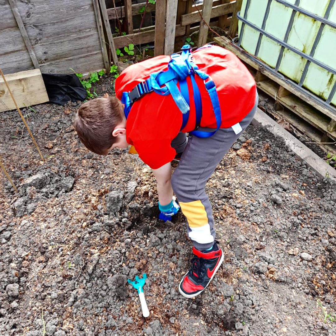 A young person looking after the garden 