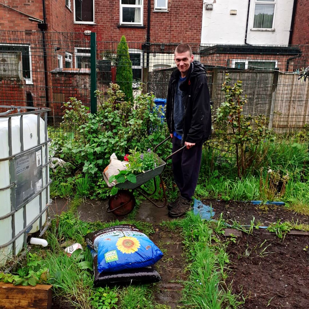 The young person's dad looking after the garden 