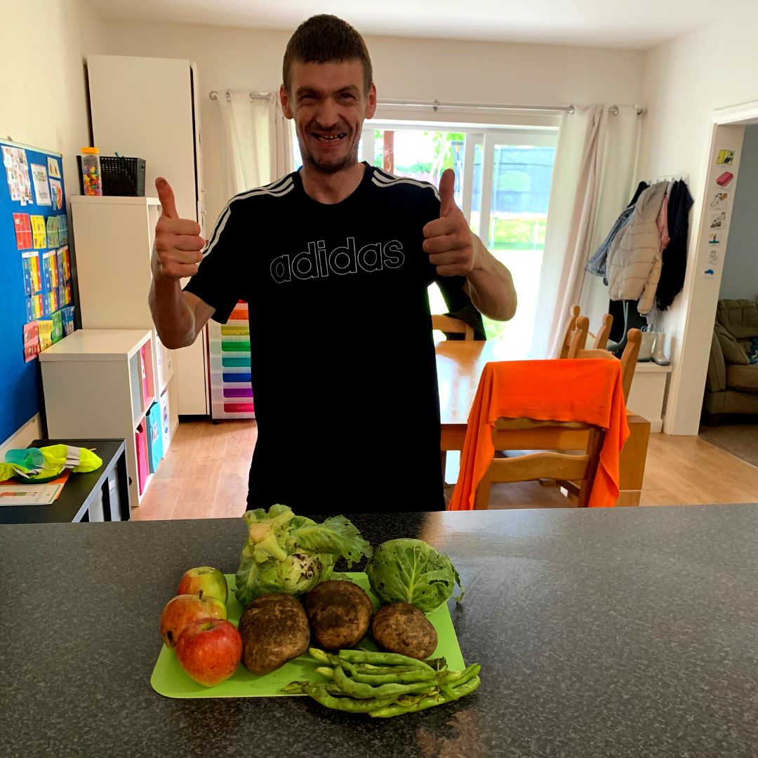 The young person's dad with the vegetables from the allotment