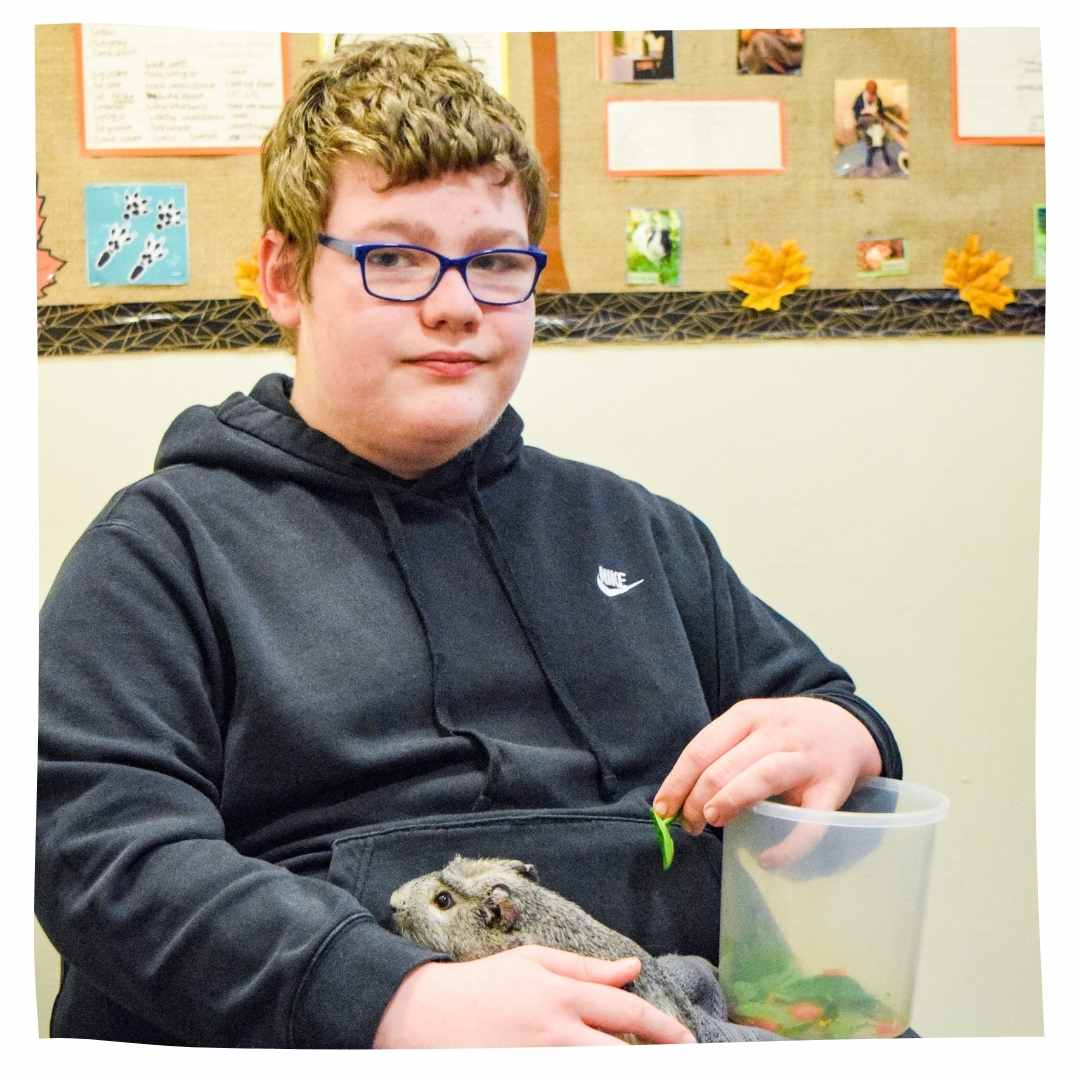 A student and guinea pig.