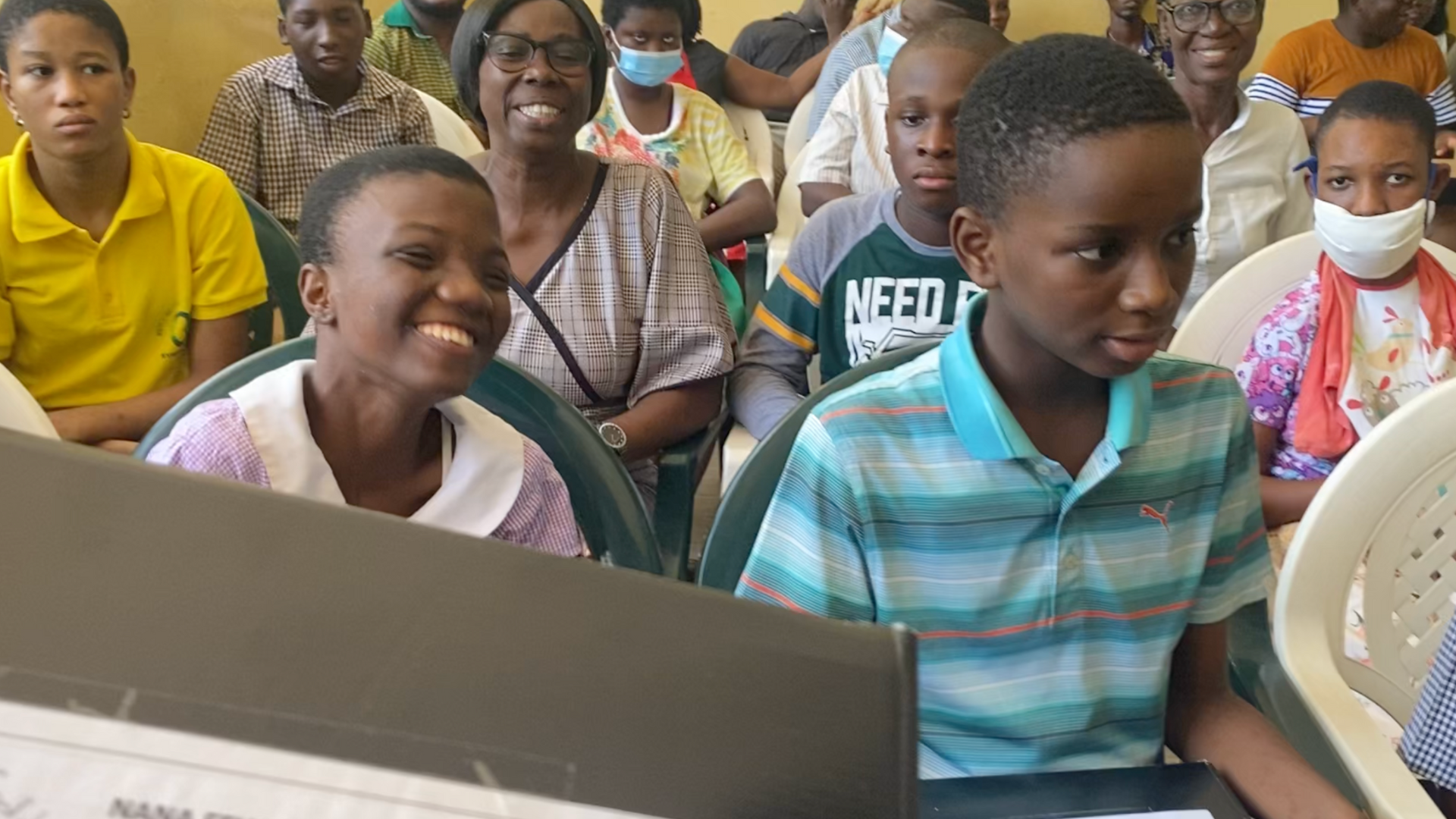 Classroom of children at New Horizon receiving their packages.