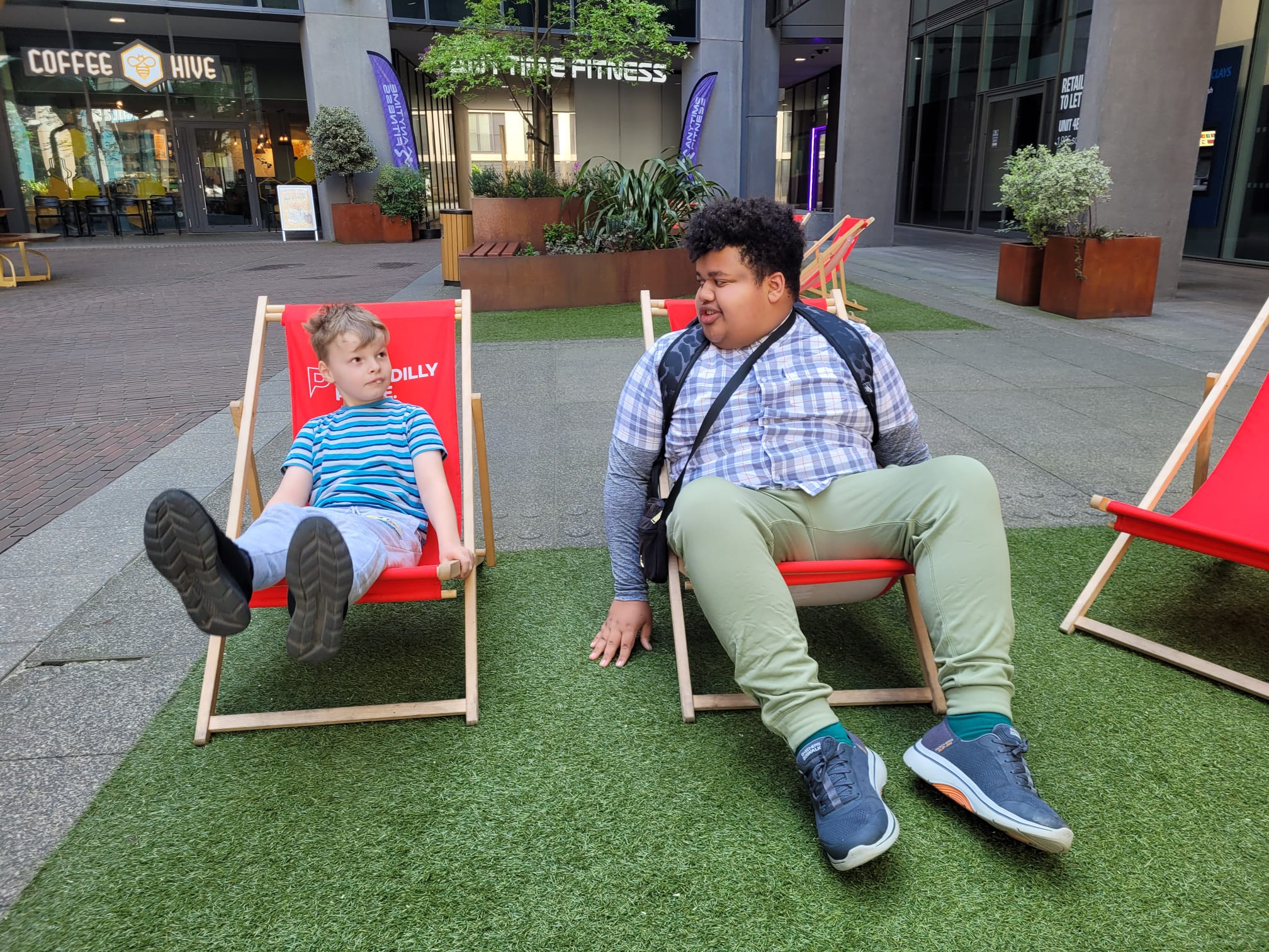 Alfie and Mason chill on sun loungers at the Barclays office