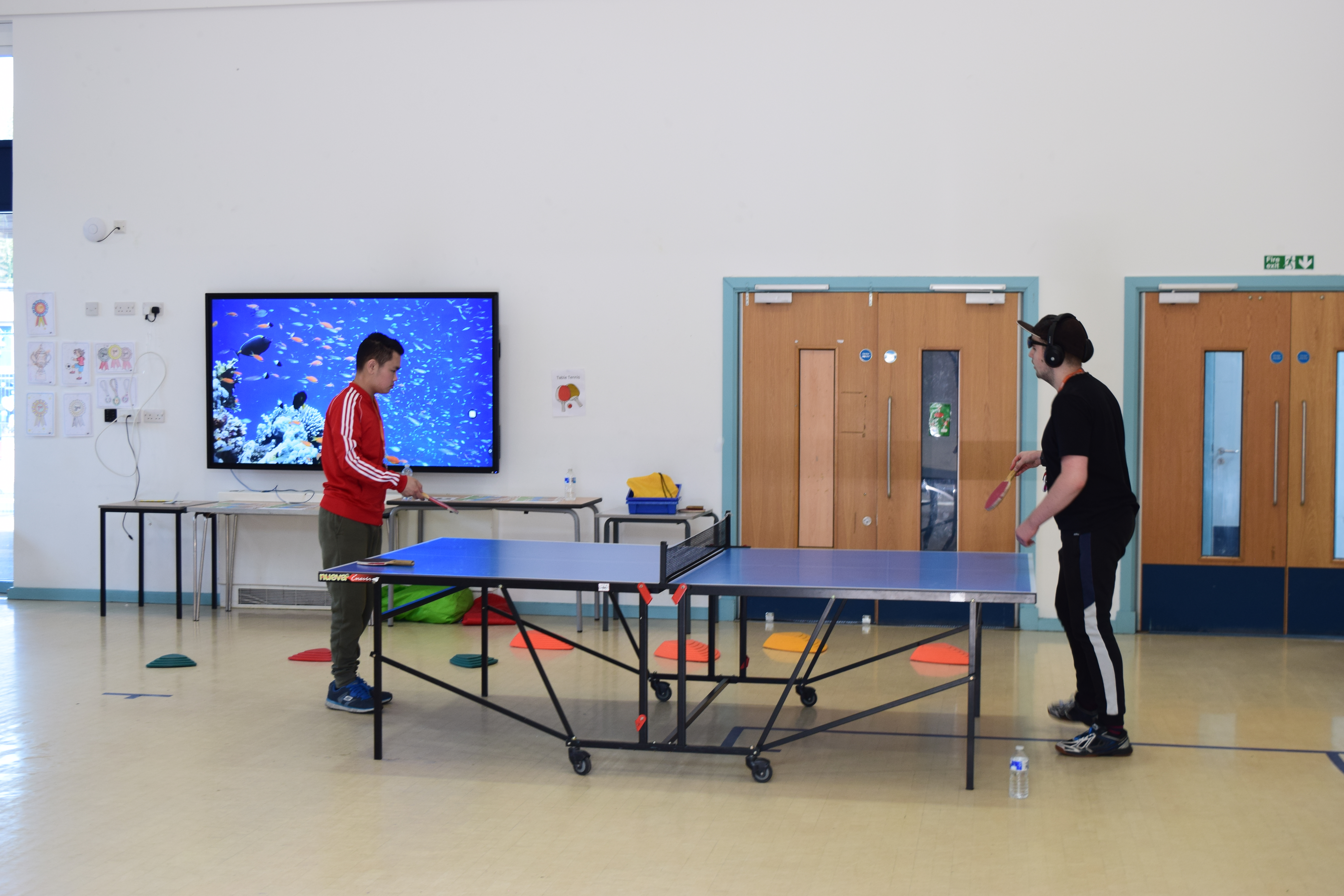 Students playing table tennis.