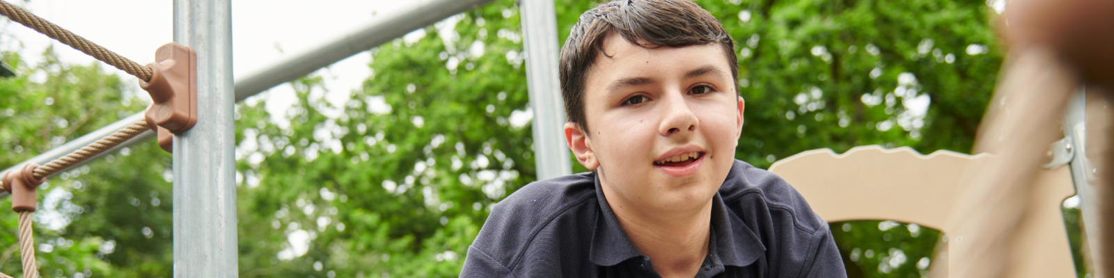 Young boy playing on an outdoors playground in the nature