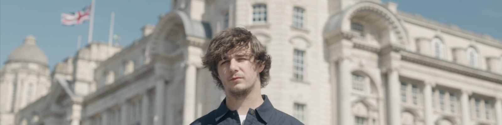 brad fella stood in front of the Liver building