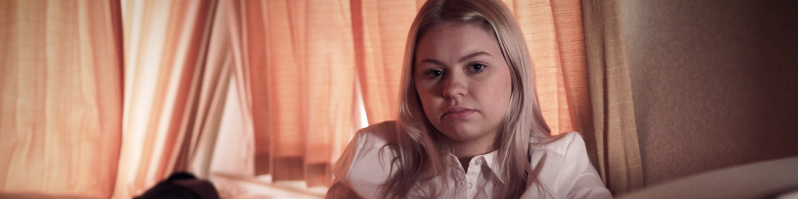 girl looking into the camera with a sad look on her face