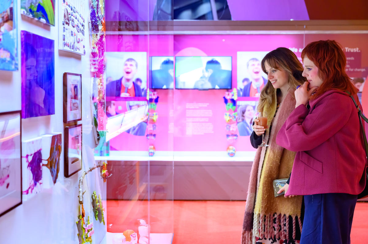 Two ladies looking at the artworks of our young people at the Lowry