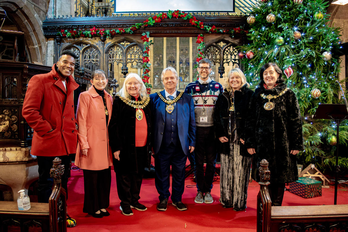 All the special guests and Trust staff posing together by the Christmas tree in the church