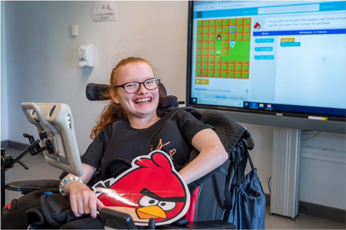 A student at Bridge College smiling 