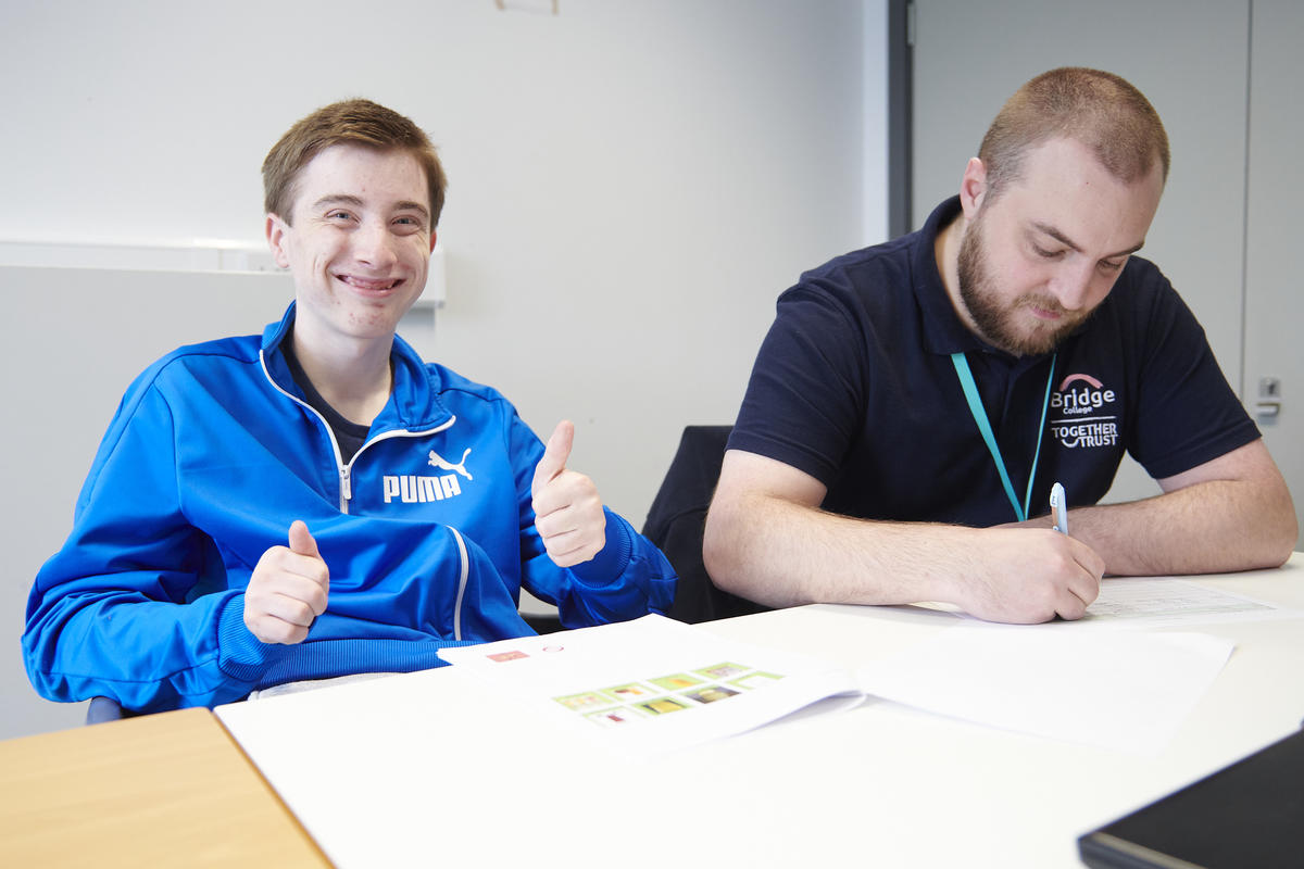 a bridge student working with a member of staff