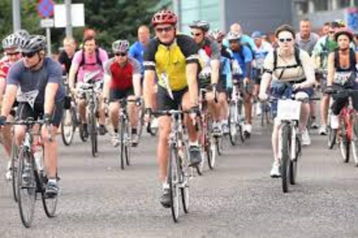 A group of cyclists in brightly coloured shirts riding towards the camera