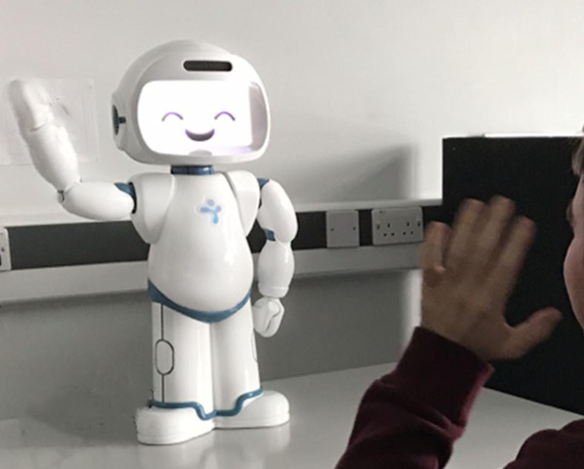 A robot waving with a person waving back at it A robot waving with a person waving back at it