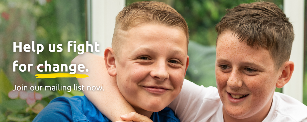 Two boys smiling with their arms around each other. The text says: 'Help us fight for change. Join our mailing list.'