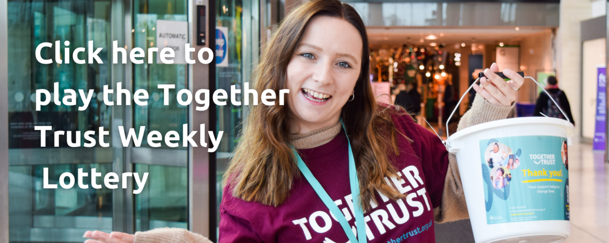 Volunteer holding a collection bucket smiling in a shopping centre. To the left the image reads "click here to play our 50:50 lottery"