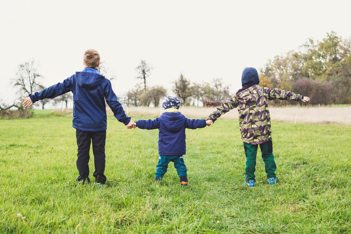 three children holding hands