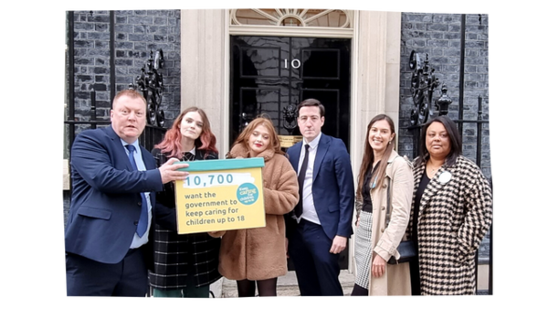 A group of 6 care leavers of various ages and ethnicities holding a petition box in front of 10 Downing Street. The box reads "10,700 want the government to keep caring for children up to 18"