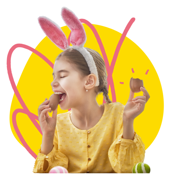 Young girl wearing a bunny headband eating a chocolate egg 