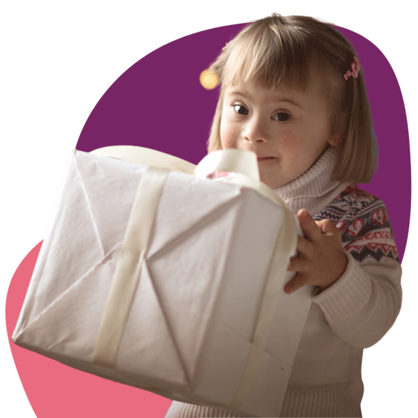a young girl holding a Christmas present