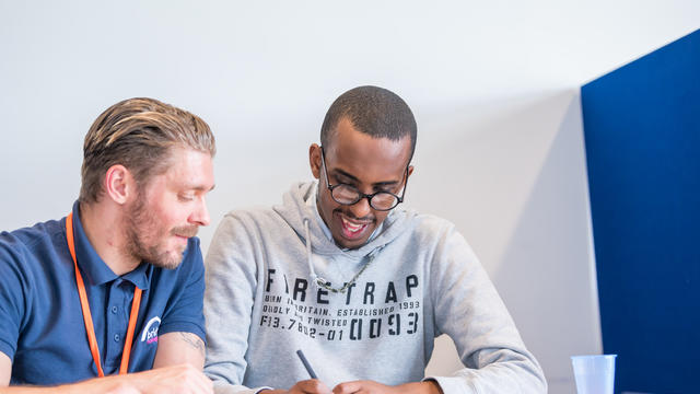 A Together Trust student working together with a staff member next to them