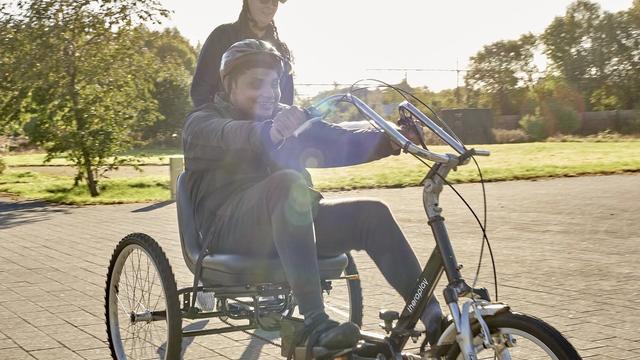 A photo of a student and staff on bikes.