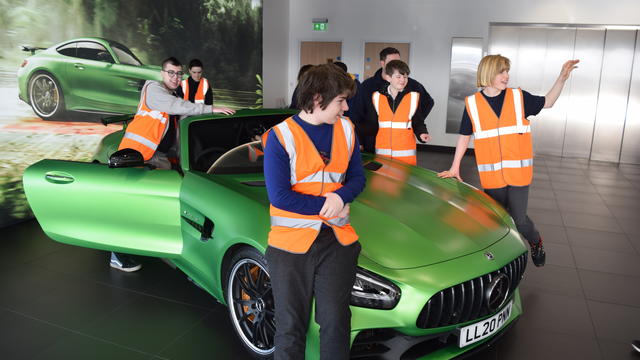 Inscape students stood around a green supercar
