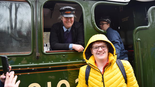 one of the students smiling with the train driver