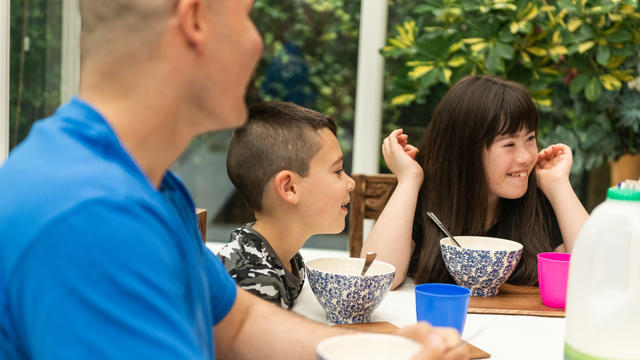 Photo of a family eating breakfast together