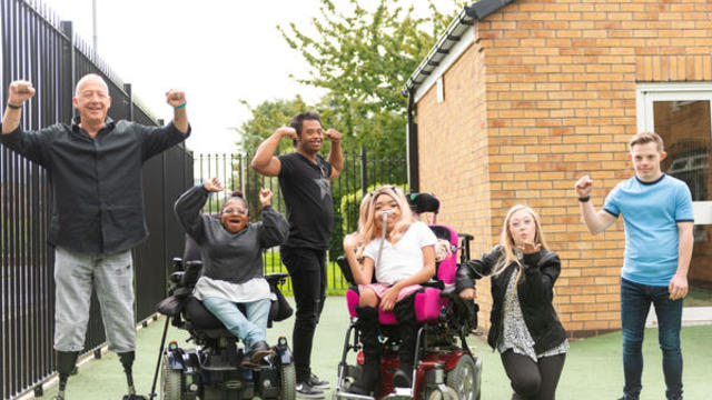 A group of people smiling at the camera 