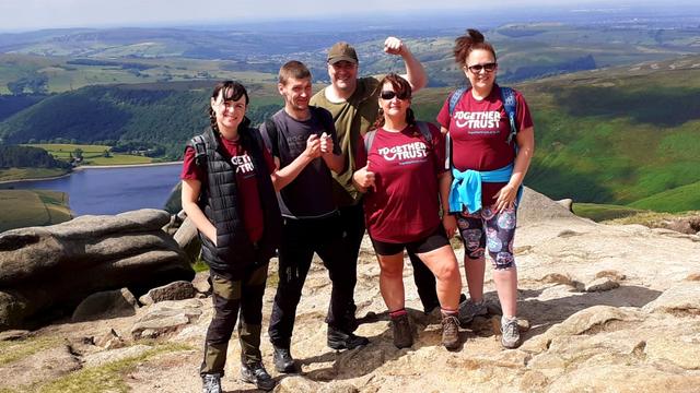 Staff members posing for a photo during their Kinder Scout challenge