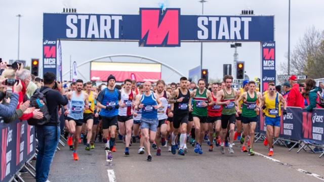 A group of runners at the start line of the Manchester Marathon