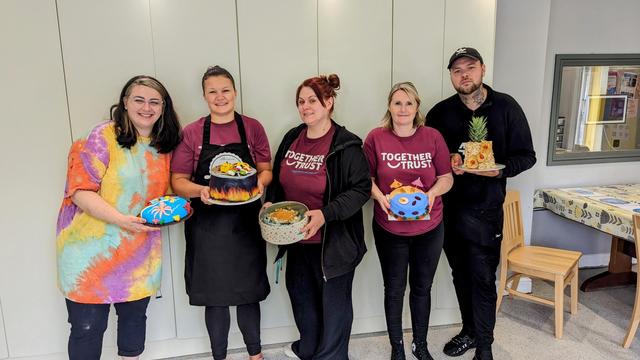 The team members from Meridian posing for a photo along with some of their culinary masterpieces.