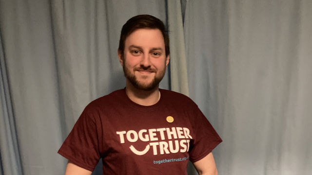 A headshot of Daniel in a Together Trust t-shirt