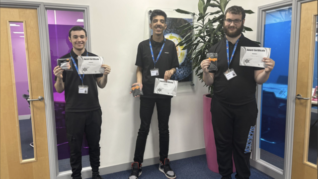 three supported internship students smiling holding certificates