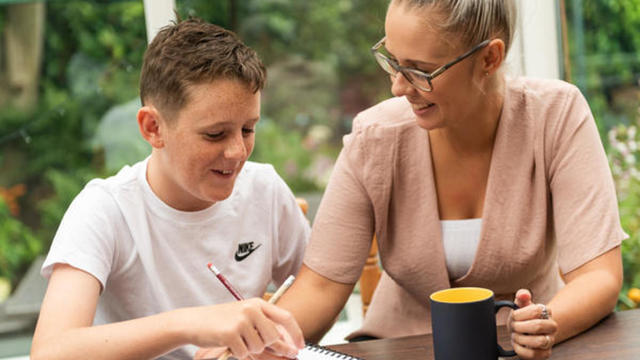 a young person talking with a woman