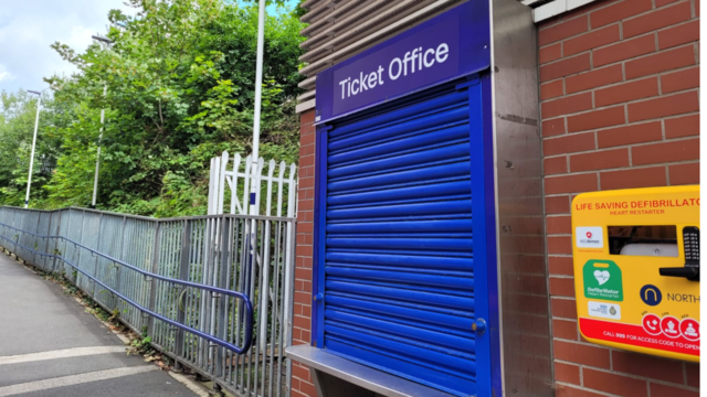 Photo of a ticket office at a train station with the blue shutter closed.
