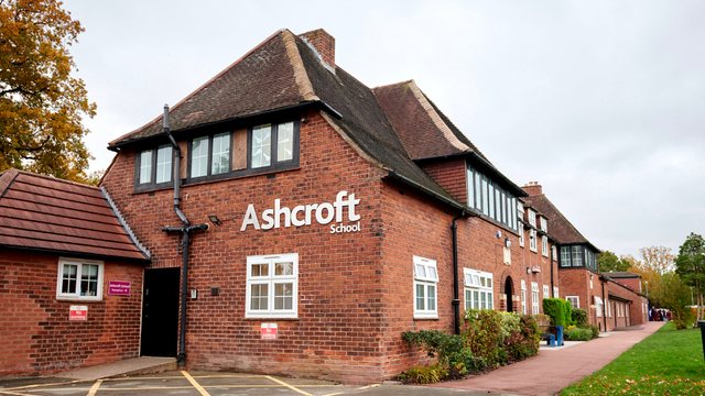 Large red brick building with sign that reads "Ashcroft School"