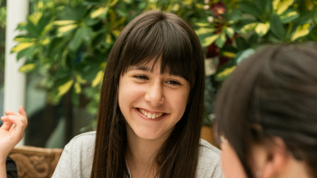 girl smiling at another person 