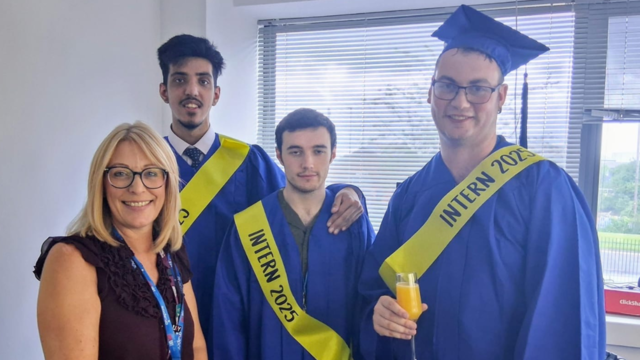 Mel Dunn, CEO of Together Trust and the graduates: Jamal, Bayley and McKenize smiling at the camera. The graduates are wearing blue caps and gowns