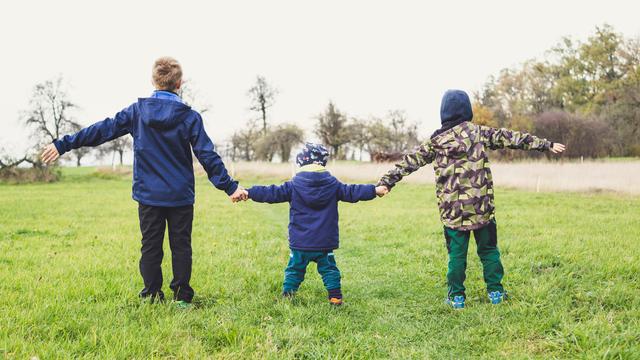 three children holding hands