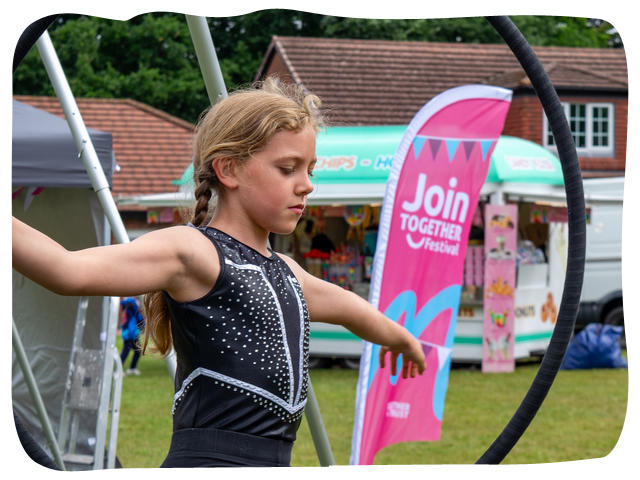 a dancer in front of a together trust branded flag
