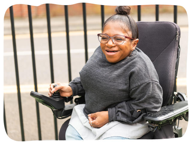 A woman in a wheelchair smiling